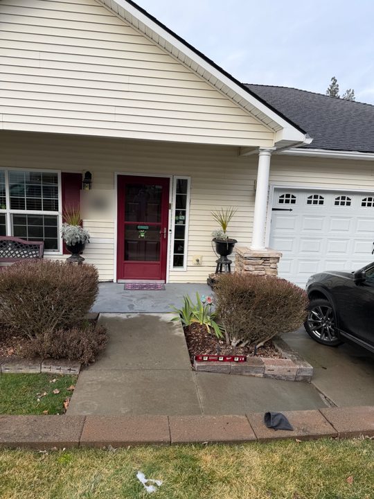Before: black handrail along a front walkway, wrapping the corner of a planter bed